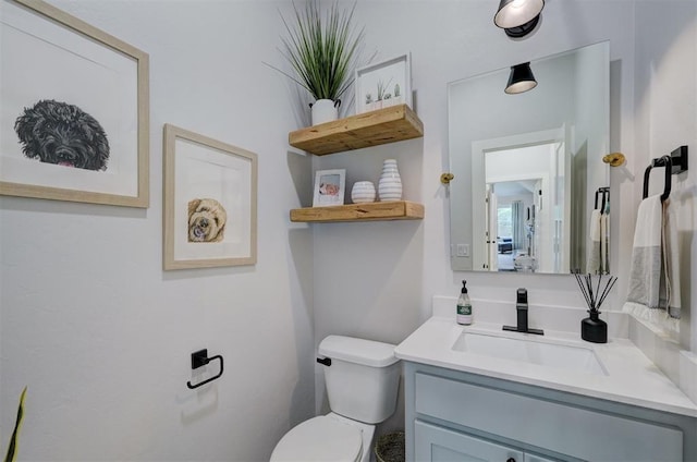 bathroom featuring vanity and toilet