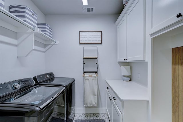 laundry area featuring cabinets and independent washer and dryer