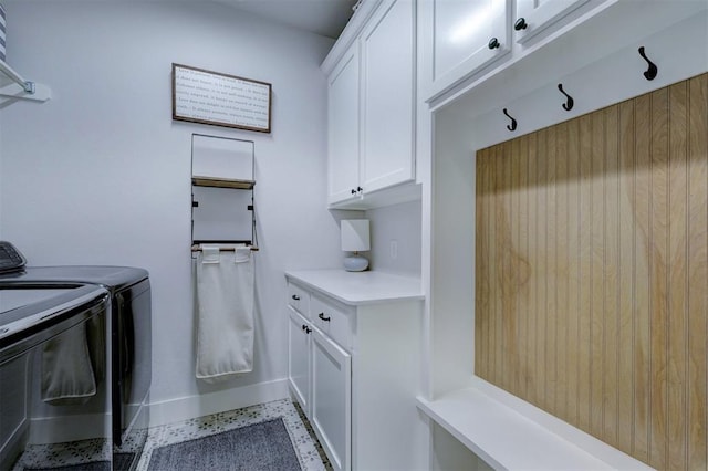 washroom featuring cabinets and washer and clothes dryer