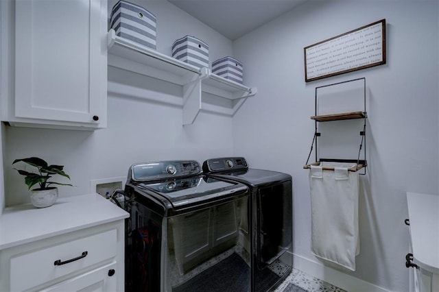 washroom featuring cabinets and washing machine and dryer