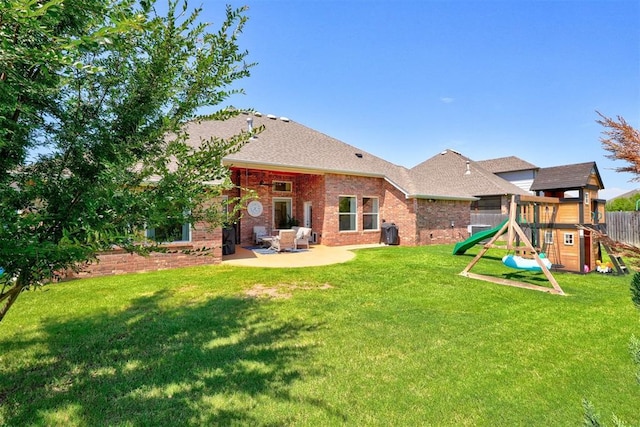 back of property featuring a yard, a playground, and a patio