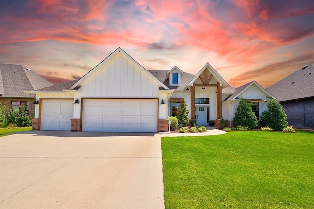 view of front of property featuring a garage and a lawn