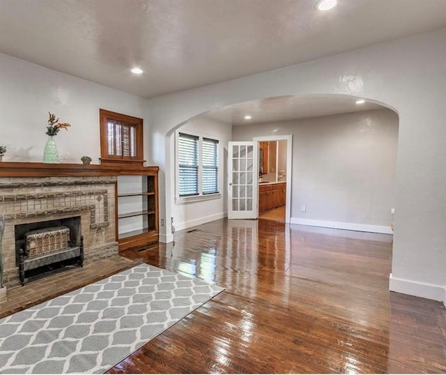 unfurnished living room with hardwood / wood-style flooring and a fireplace