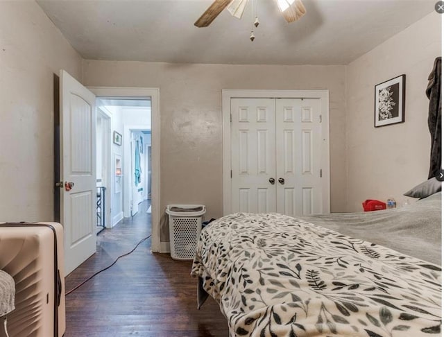 bedroom featuring ceiling fan, dark hardwood / wood-style flooring, and a closet