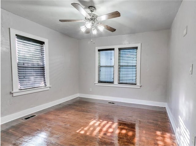 unfurnished room with dark hardwood / wood-style floors and ceiling fan