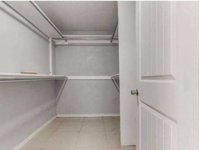 walk in closet featuring light tile patterned floors