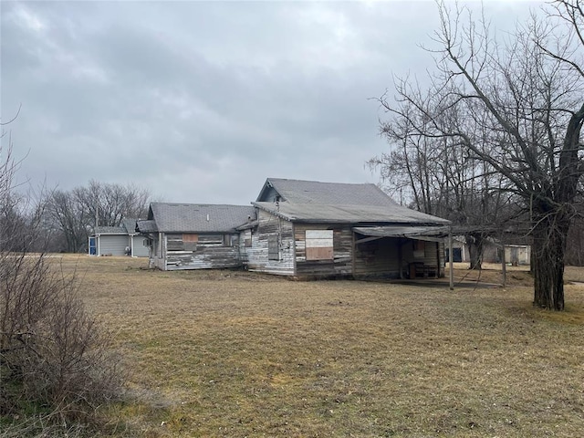 rear view of property featuring a lawn