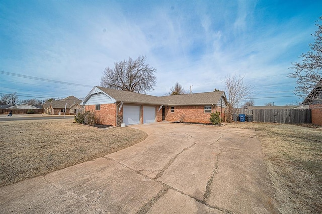 single story home with a garage and a front lawn