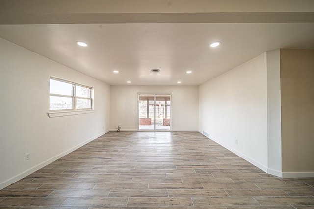 empty room with hardwood / wood-style floors