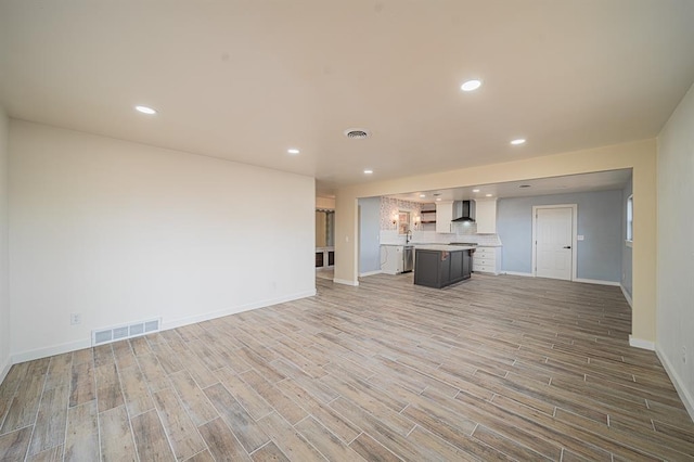 unfurnished living room with hardwood / wood-style floors