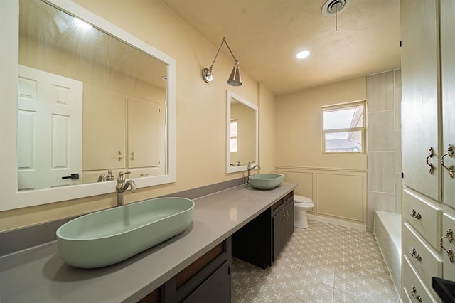 full bathroom featuring vanity, washtub / shower combination, and toilet