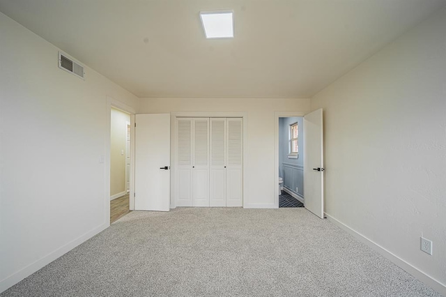 unfurnished bedroom with carpet and a closet