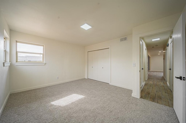 unfurnished bedroom with carpet floors and a closet