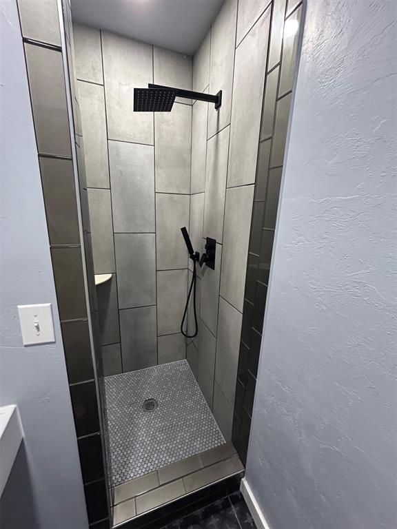 bathroom with a tile shower