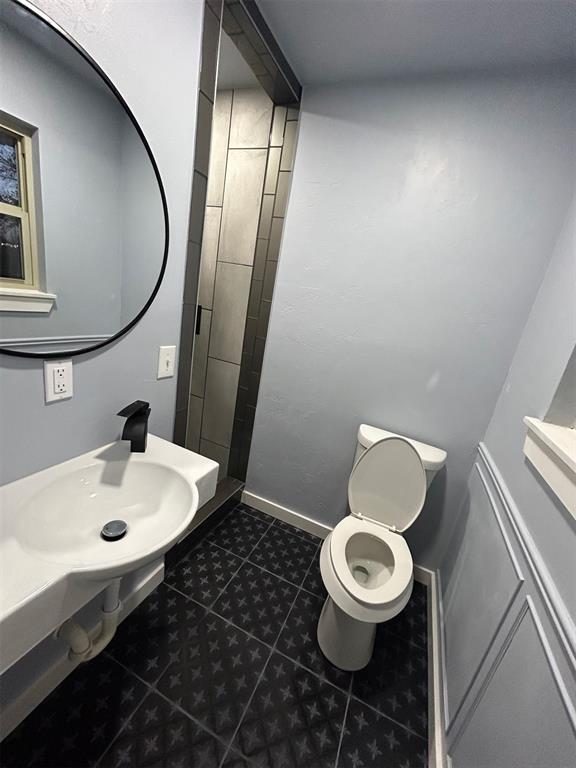 bathroom with tile patterned flooring and toilet