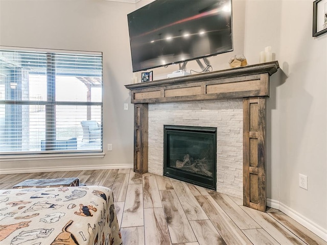 bedroom with a fireplace and wood-type flooring