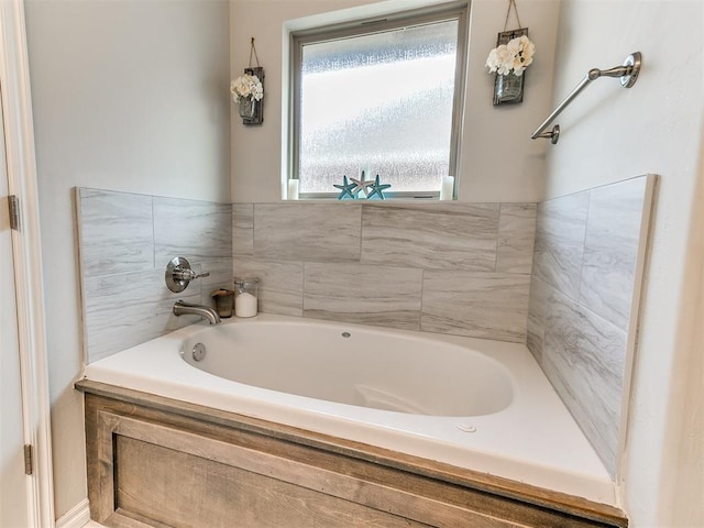 bathroom with a tub to relax in