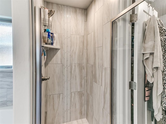 bathroom featuring a shower with door