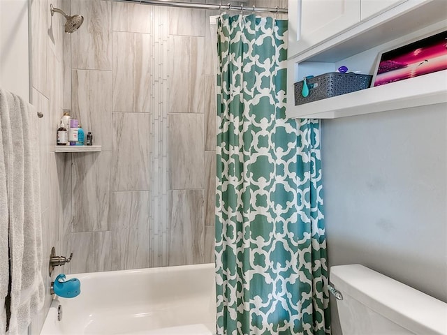 bathroom featuring shower / tub combo and toilet