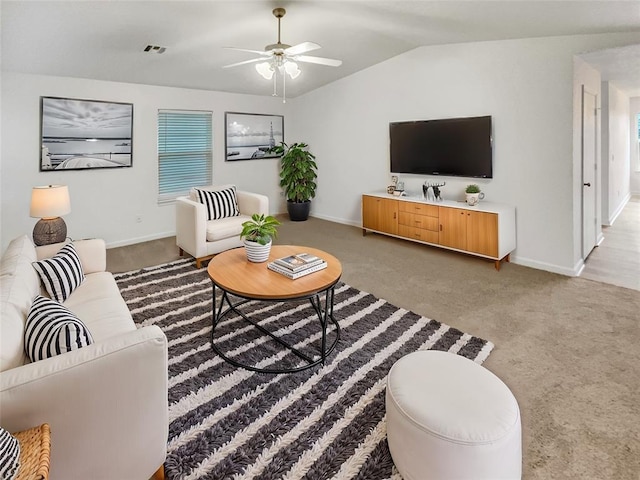 carpeted living room featuring vaulted ceiling and ceiling fan