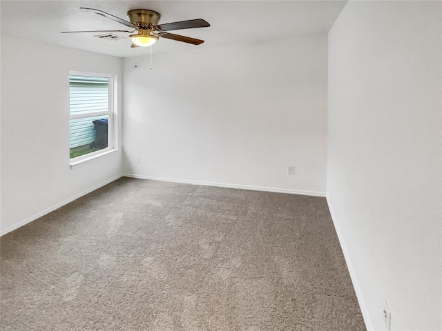 empty room with ceiling fan and carpet flooring