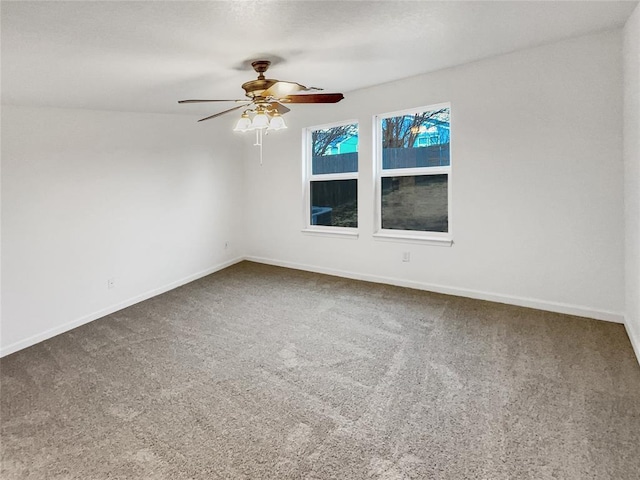 unfurnished room with ceiling fan and carpet