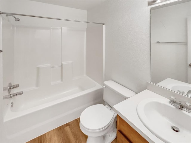 full bathroom with hardwood / wood-style flooring, toilet, vanity, and shower / bathing tub combination