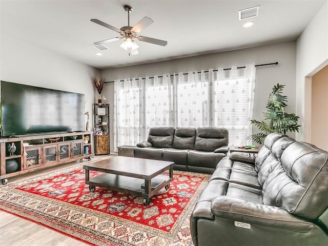 living room with hardwood / wood-style flooring and ceiling fan