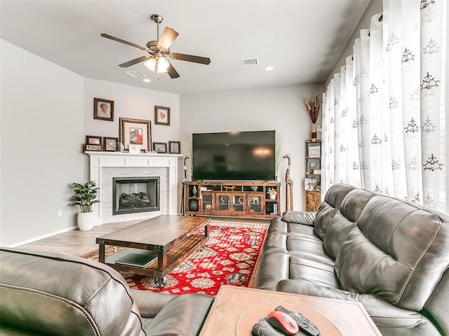 living room with wood-type flooring and ceiling fan