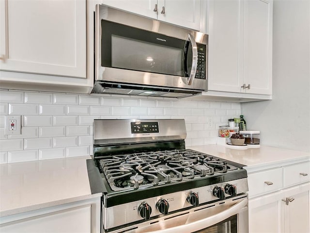 kitchen featuring white cabinetry, appliances with stainless steel finishes, and decorative backsplash