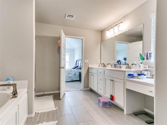 bathroom featuring vanity and a tub