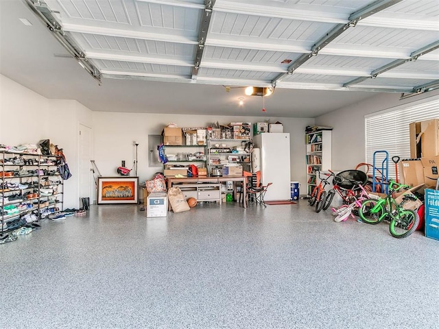 garage with white refrigerator and a garage door opener