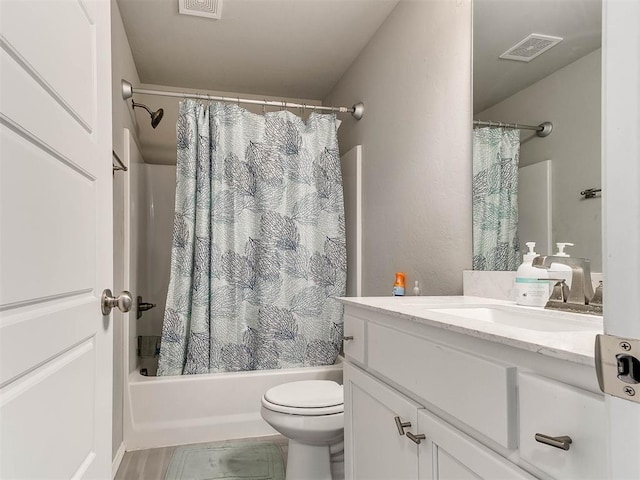 full bathroom with vanity, toilet, and shower / tub combo