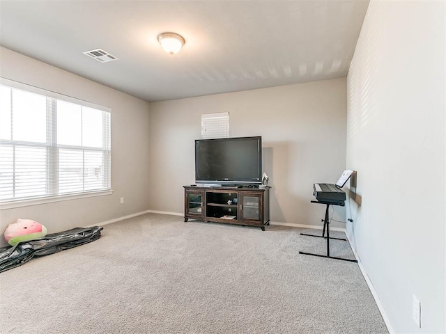 workout room featuring light colored carpet