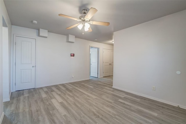 spare room with ceiling fan and light wood-type flooring