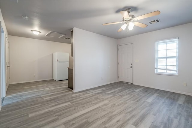 spare room with light hardwood / wood-style floors and ceiling fan