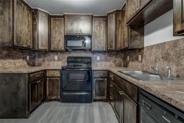 kitchen featuring backsplash, dark brown cabinetry, sink, and black appliances