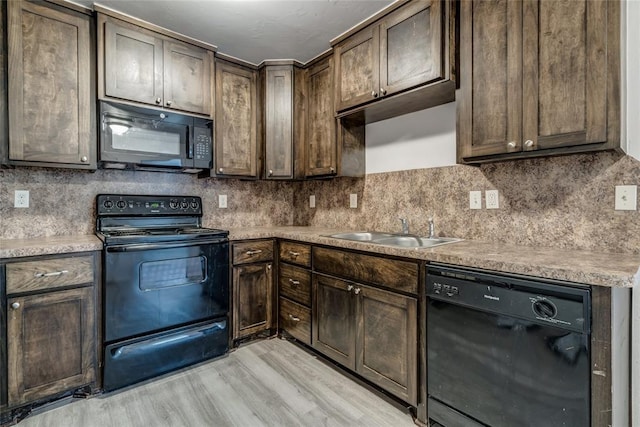 kitchen featuring sink, tasteful backsplash, light hardwood / wood-style flooring, dark brown cabinets, and black appliances