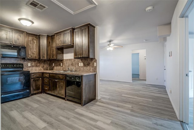 kitchen featuring tasteful backsplash, sink, dark brown cabinets, and black appliances