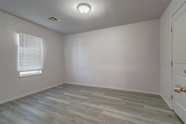 spare room with light hardwood / wood-style flooring