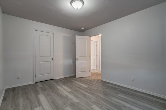 unfurnished bedroom featuring light wood-type flooring