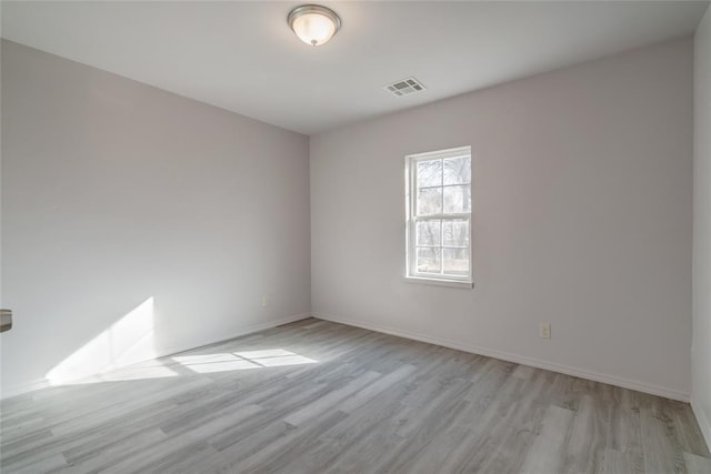 empty room with light hardwood / wood-style flooring