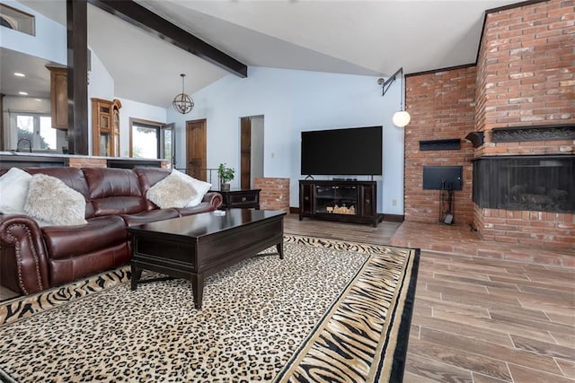 living room featuring a brick fireplace, lofted ceiling with beams, and sink