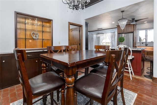 dining area featuring sink and a chandelier