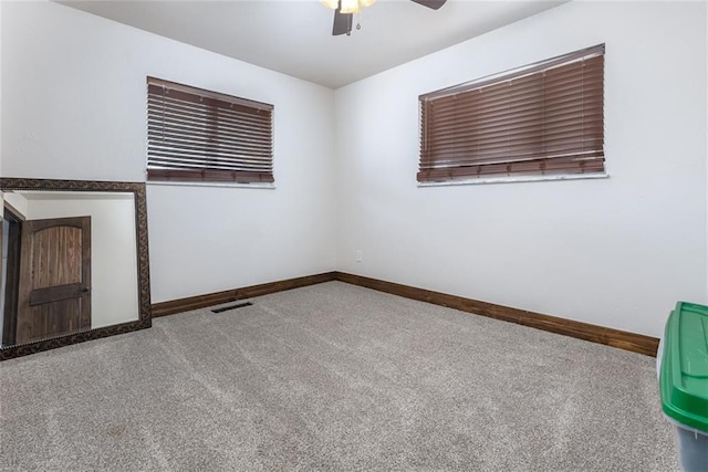 carpeted empty room featuring ceiling fan