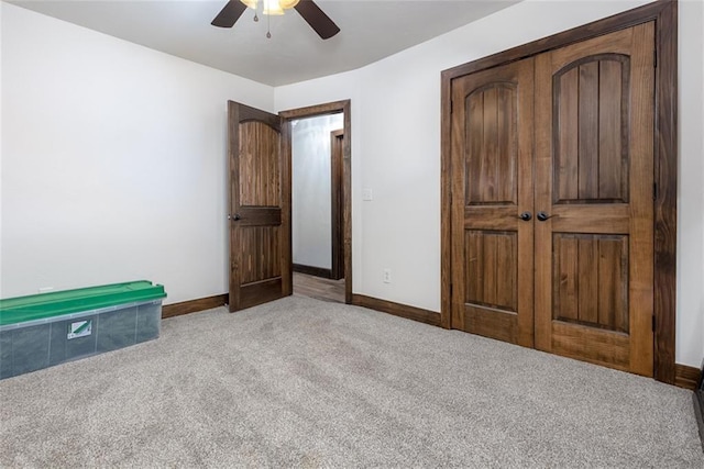 unfurnished bedroom featuring light colored carpet, ceiling fan, and a closet