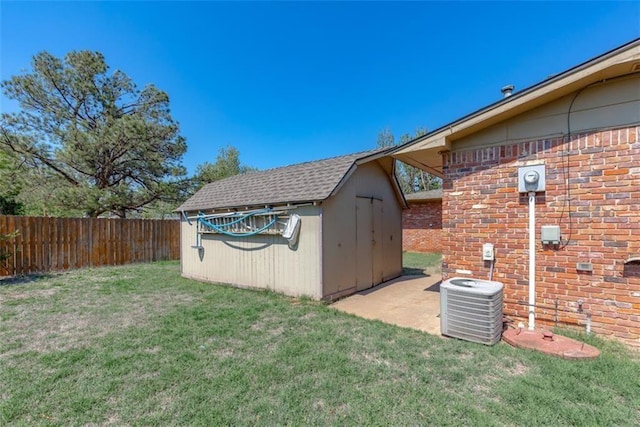 view of outbuilding with a yard and central AC unit