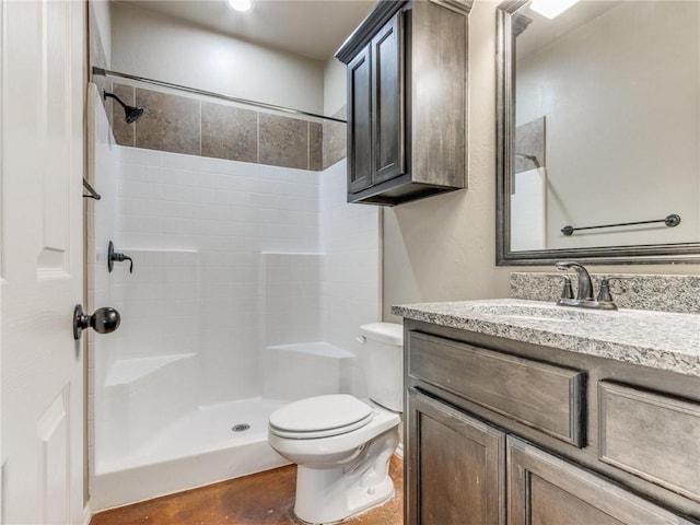 bathroom with toilet, vanity, and walk in shower