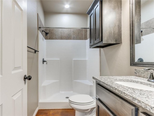 bathroom featuring vanity, a shower, and toilet