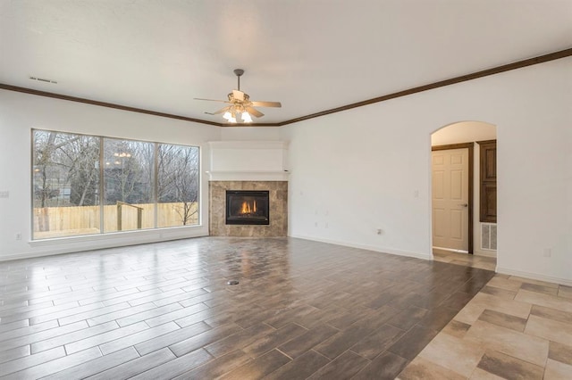 unfurnished living room with ornamental molding, a fireplace, light hardwood / wood-style floors, and ceiling fan